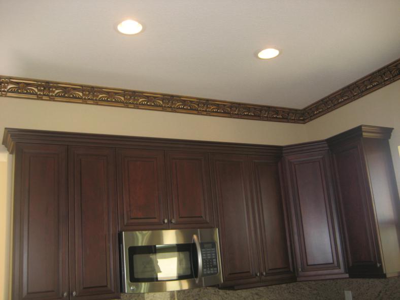 Kitchen cabinets finished with ornate crown molding
