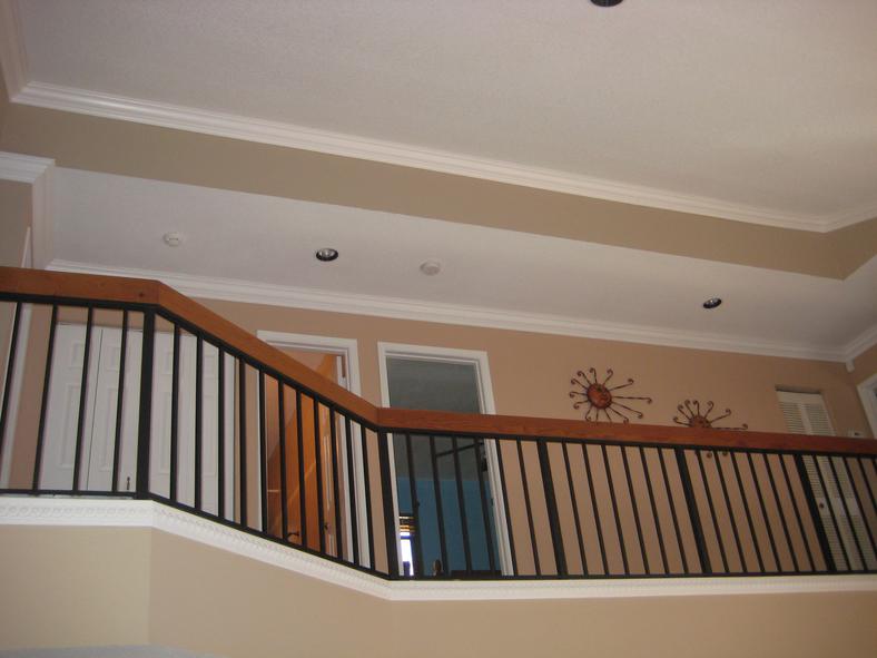 Two-story foyer with crown molding and detailed trim