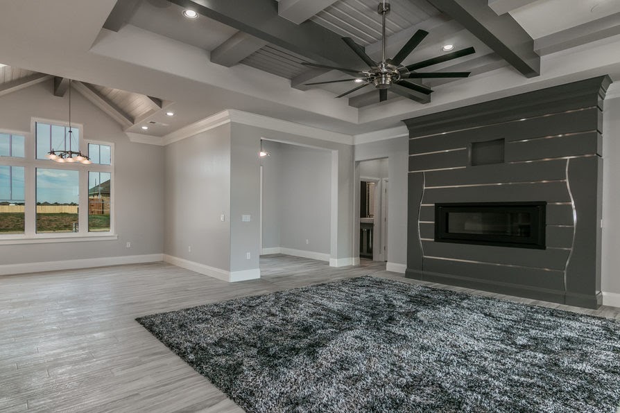 Living room with beamed ceiling and shiplap fireplace wall